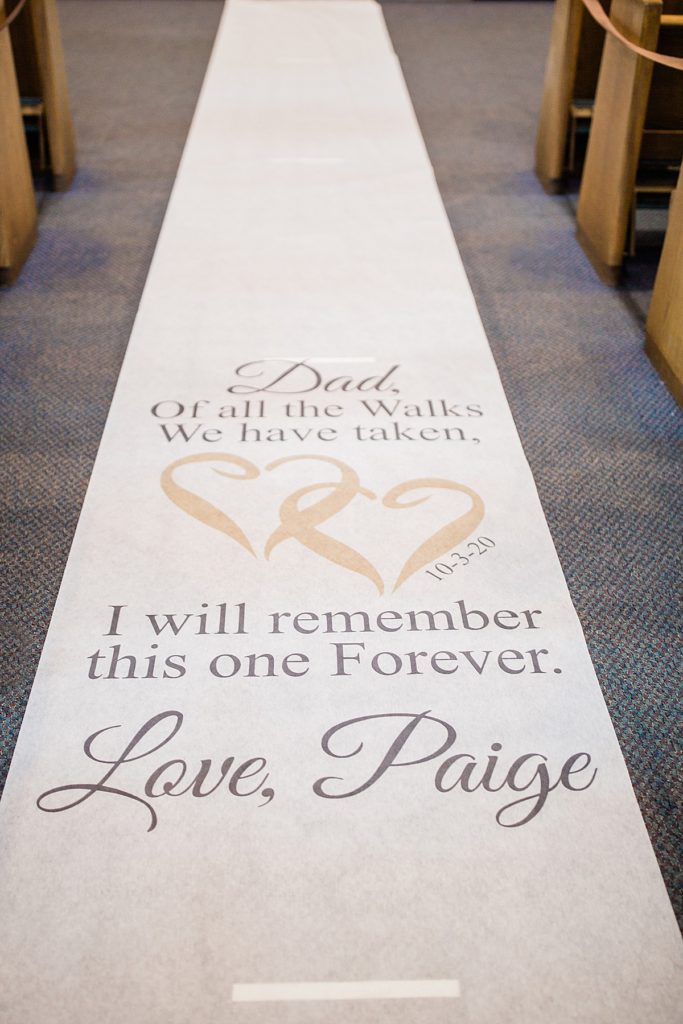 wedding aisle runner with a note to the bride's dad