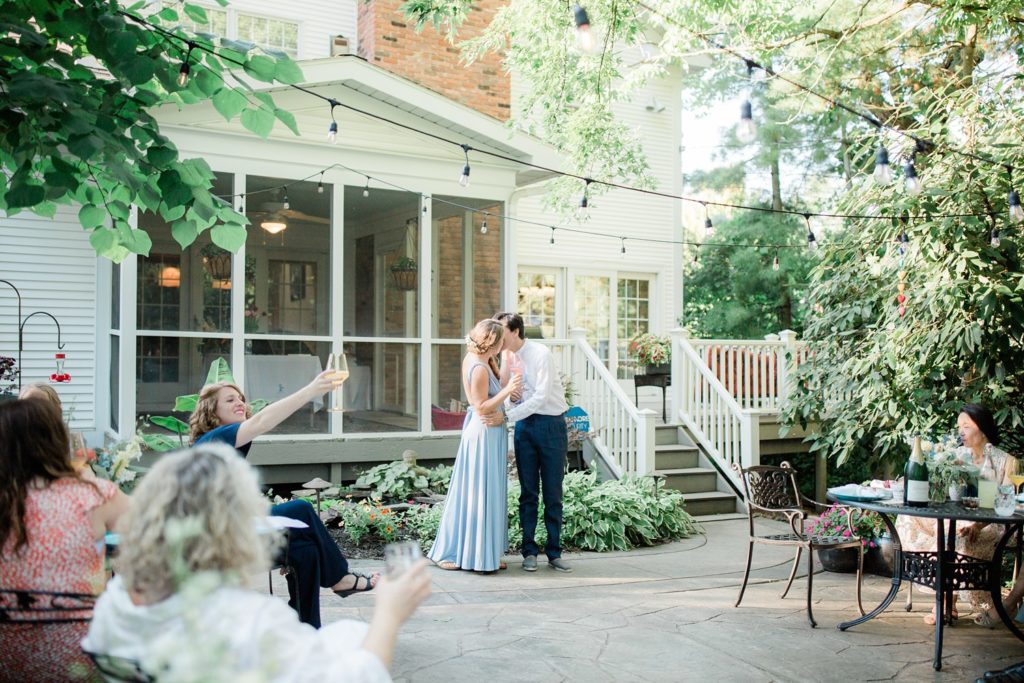 backyard wedding bride and groom kiss