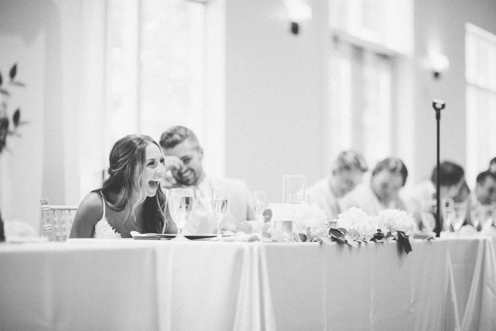 candid bride and groom during toasts