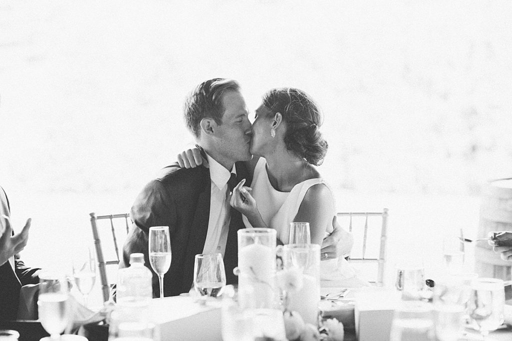 bride and groom toast kiss