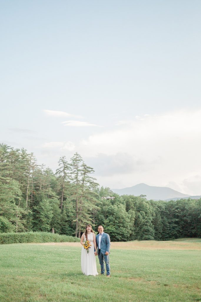 bride and groom portraits with mountain background
