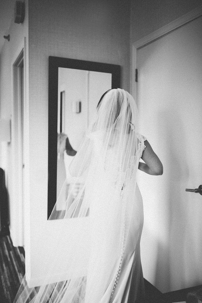 bride looking at herself in the mirror