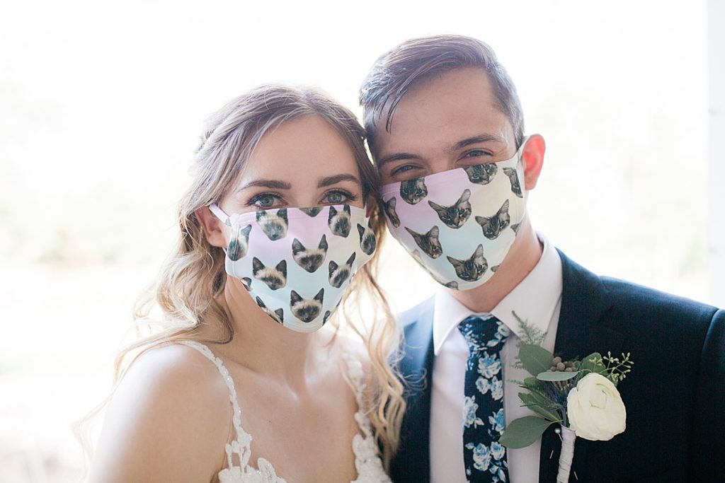 bride and groom in their cat masks
