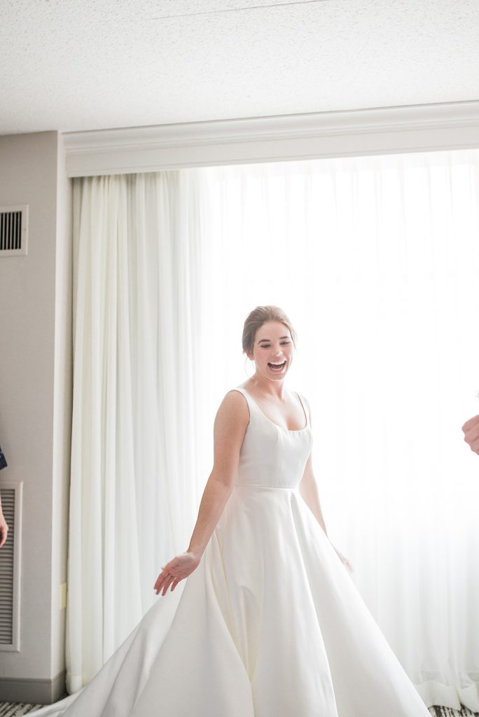 bride twirling after putting her dress on