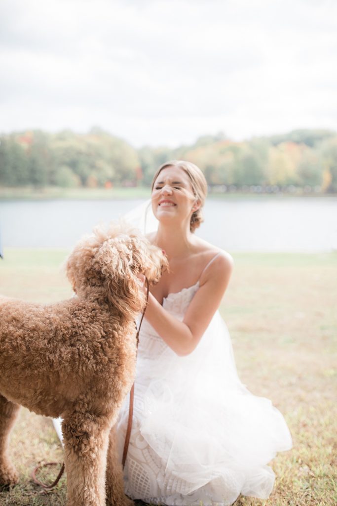 bride playing with her golden doodle puppy