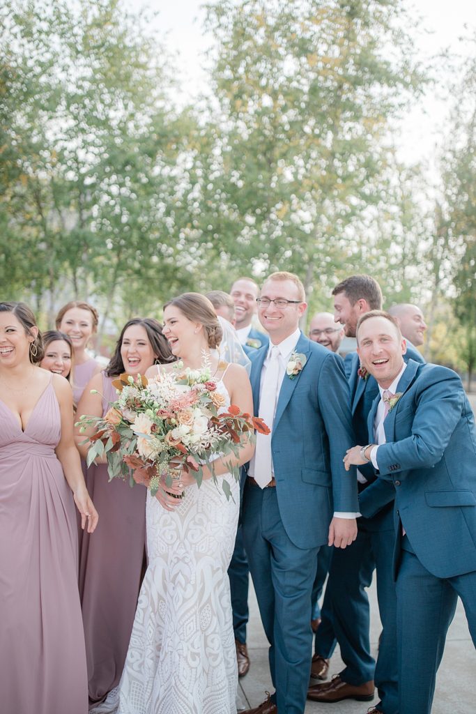 bridal party laughing with bride and groom