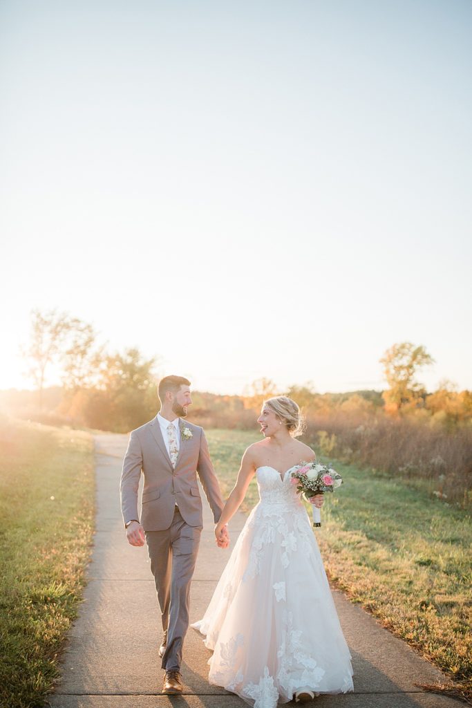 bride and groom walking during sunset at Blue Heron
