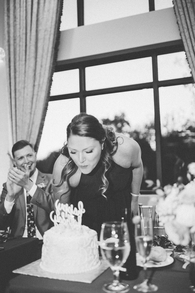 maid of honor blowing out birthday candles