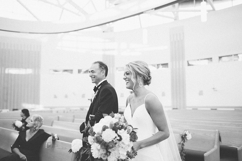 bride and dad laughing in the church