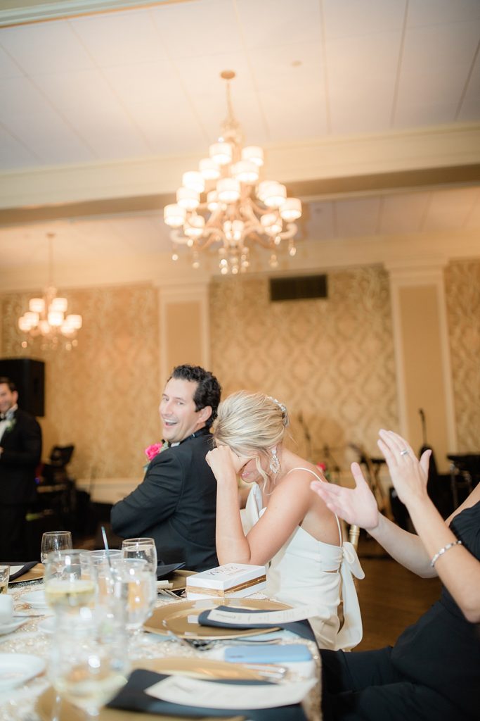 bride laughing during toasts