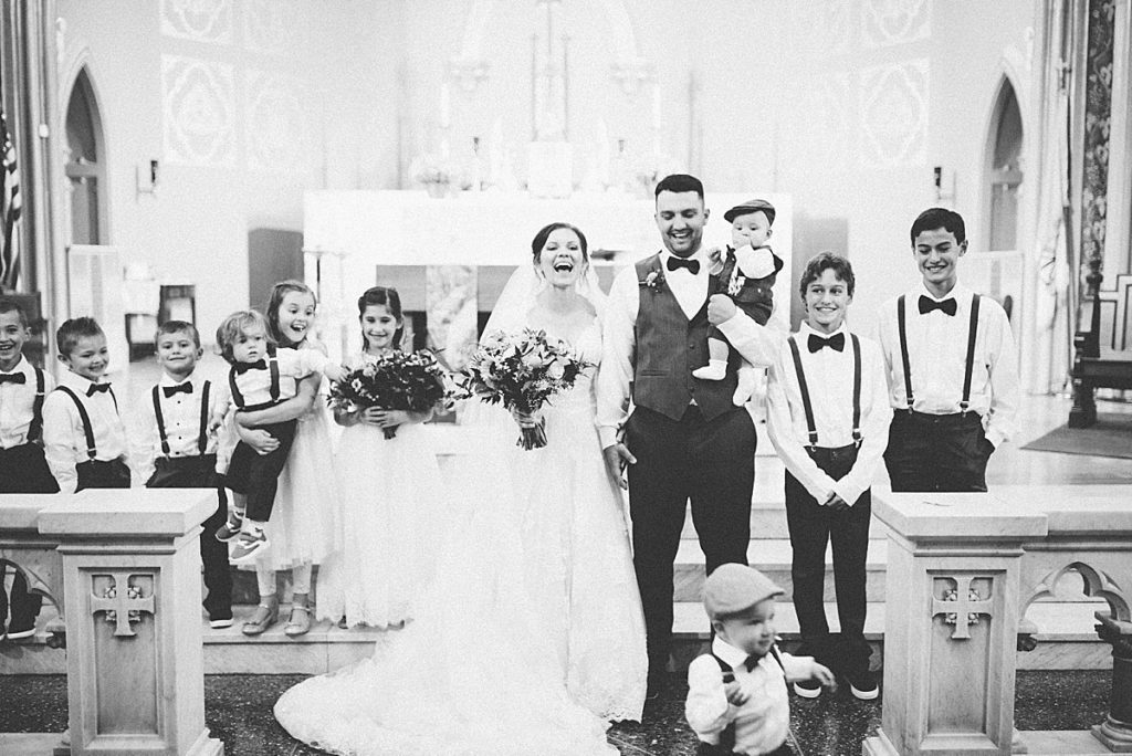 formal portraits if the kids on the altar with the bride and groom
