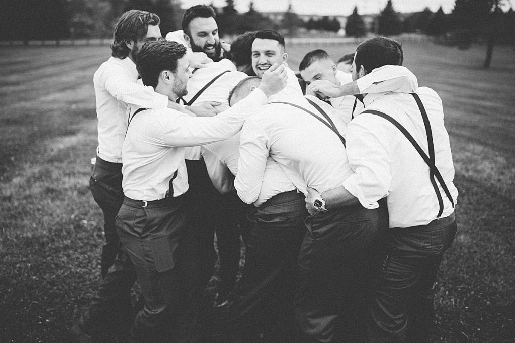 groomsmen hugging groom