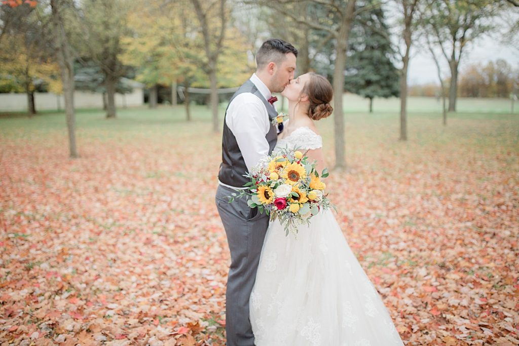 bride and groom portraits in fall leaves