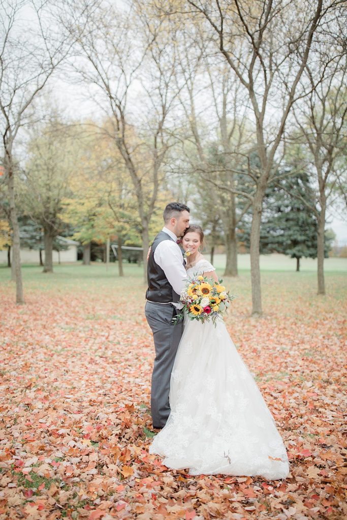 bride and groom portraits in fall leaves