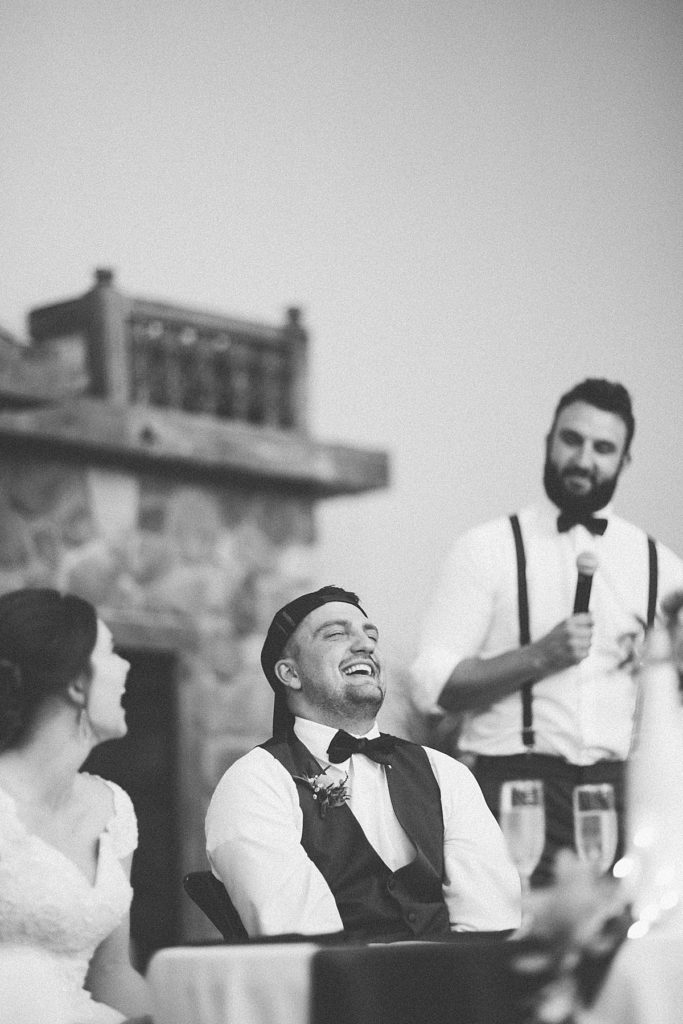 groom laughing during toasts