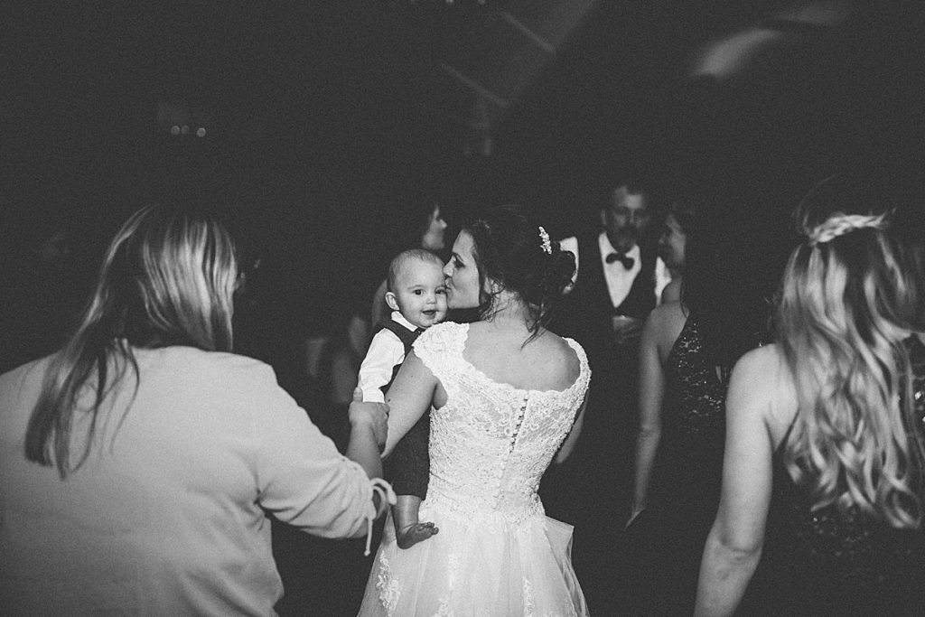 bride kissing son on dance floor