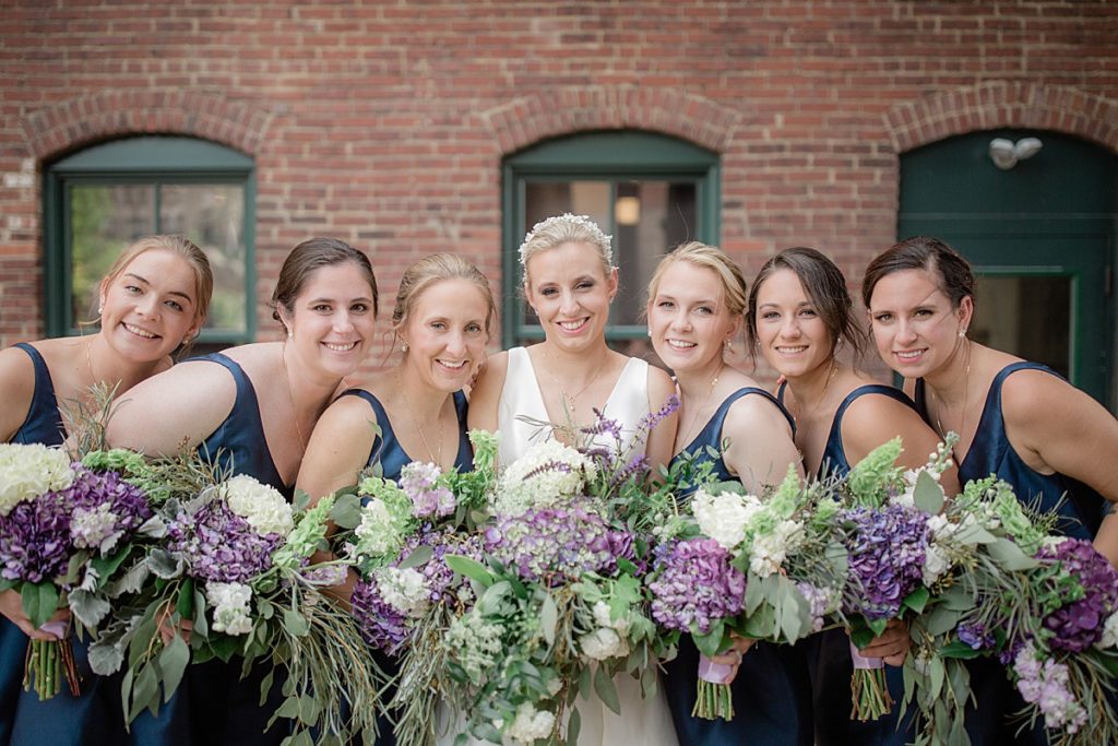 bridesmaids and bride smiling