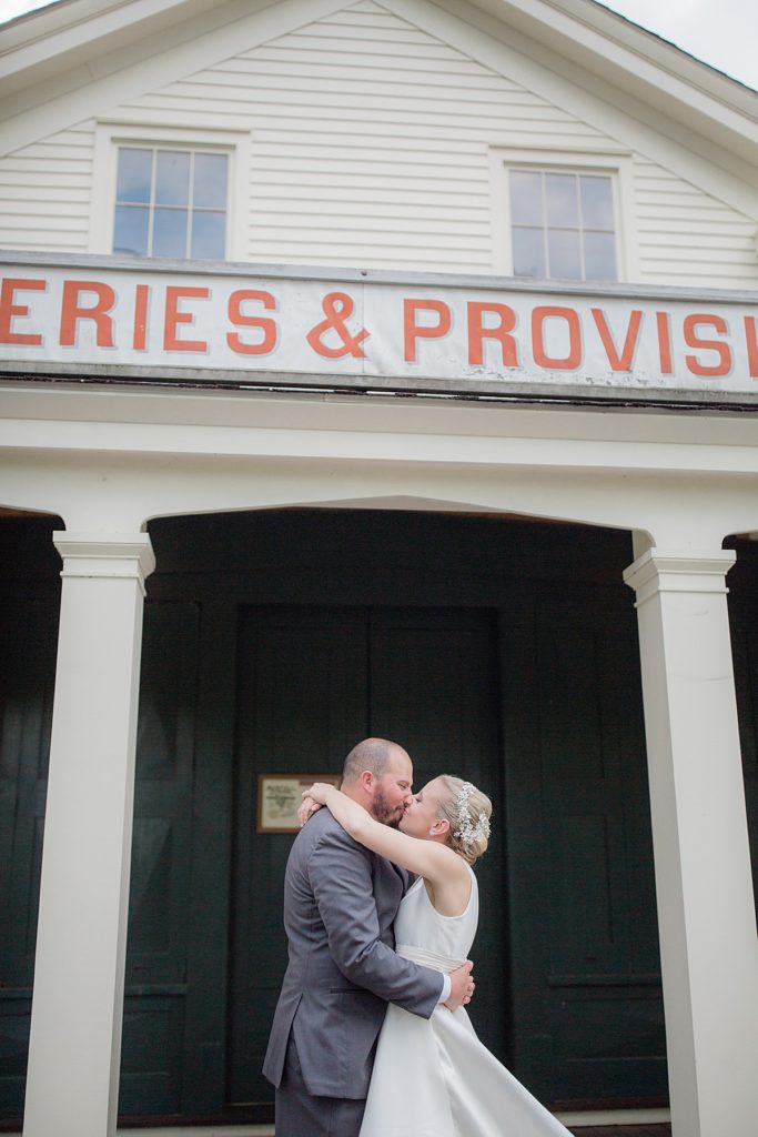 Bride and Groom kiss in front of Mustill Storehead