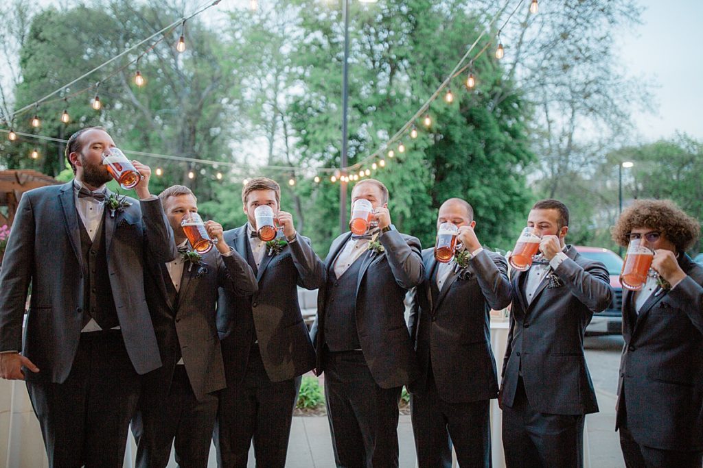 groomsmen drinking out of their beer steins