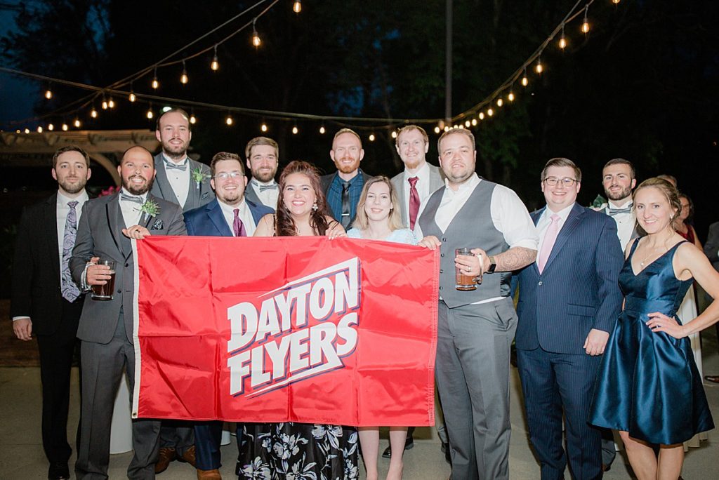 candid reception photo with the Dayton Flyers flag
