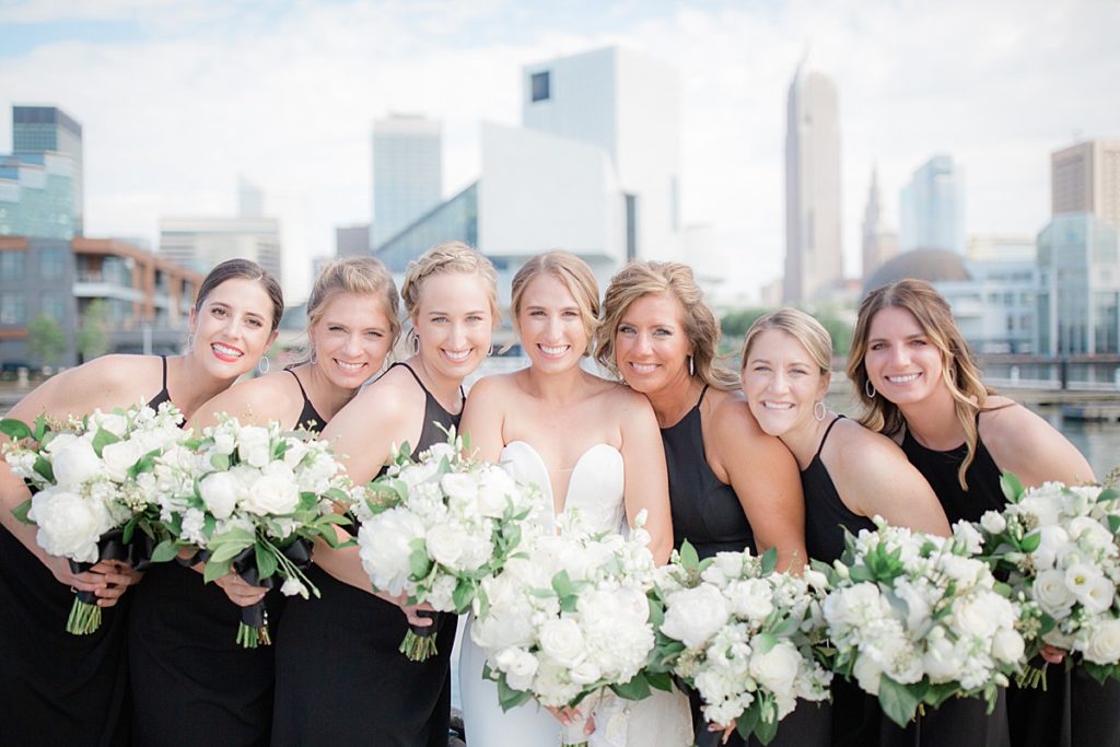 bridesmaids with the bride at the Cleveland skyline behind them