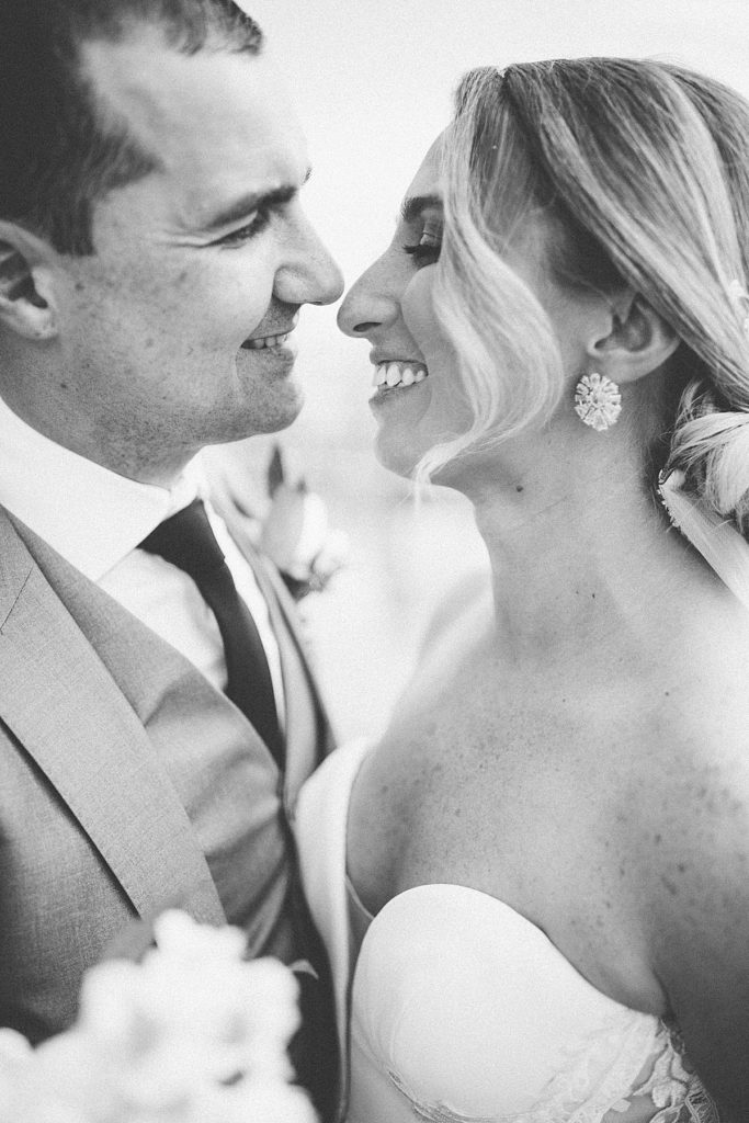 close up of bride and groom with noses almost touching