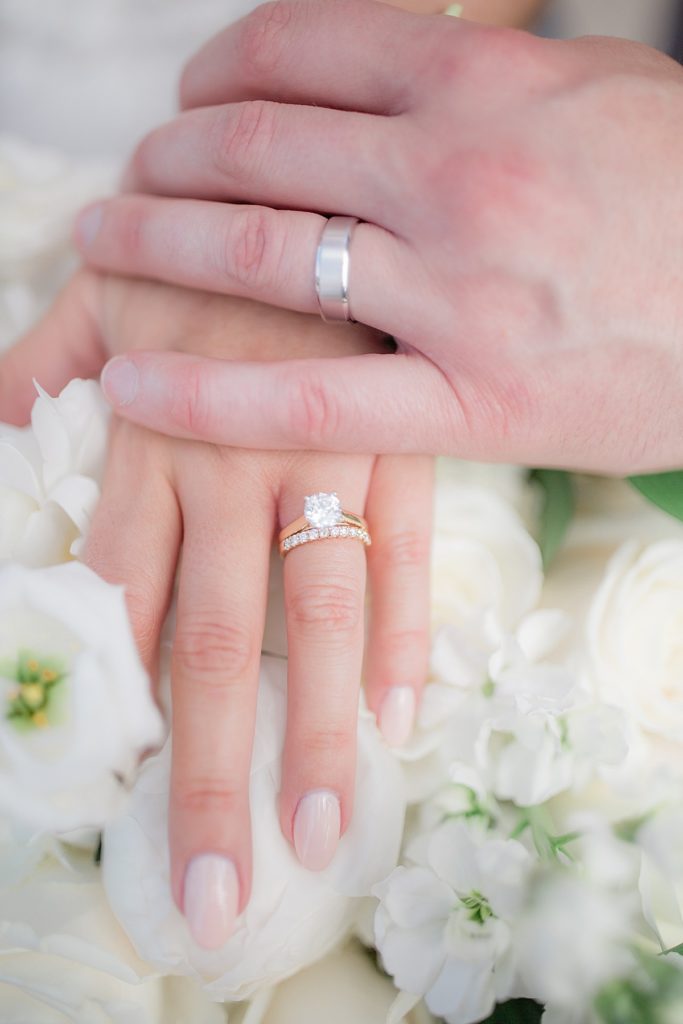 detail photograph of the wedding rings and bridal bouquet