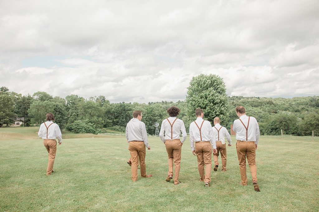 groomsmen walking in the field
