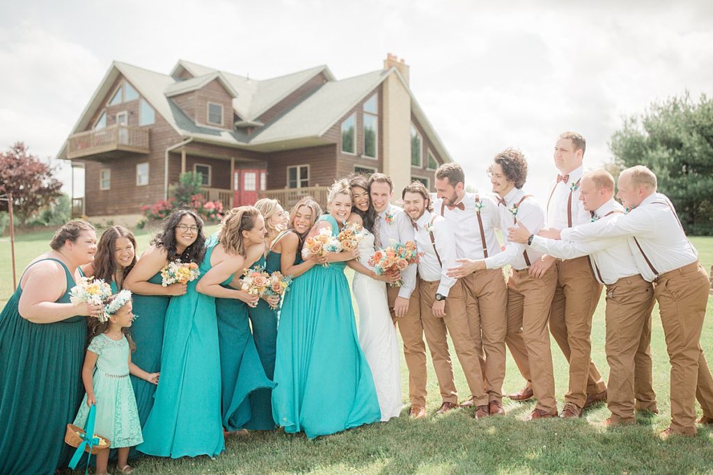 all of the bridal party hugging