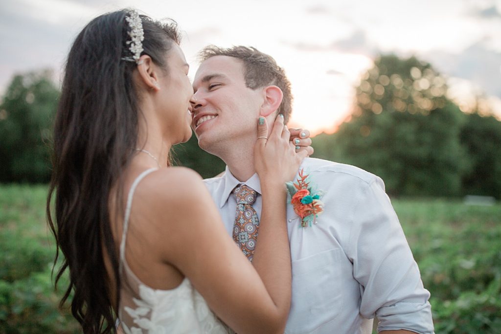 bride and groom about to kiss during sunset