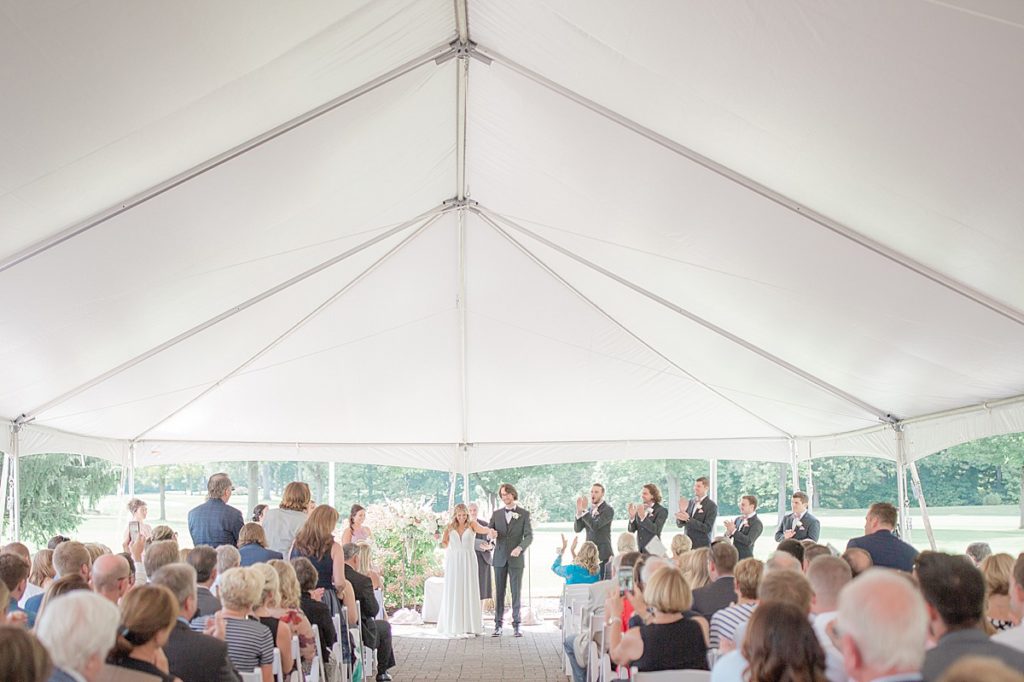 country club wedding ceremony in a tent