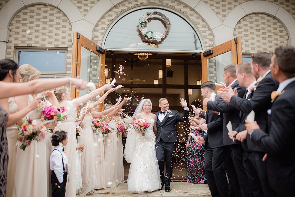 bride and groom exit the wedding ceremony in Akron, Ohio
