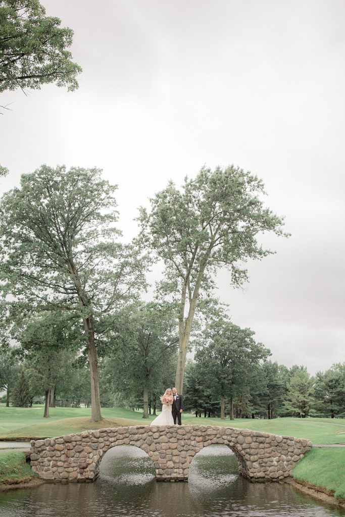 the bride and groom are on the firestone country club golf course for a few portraits