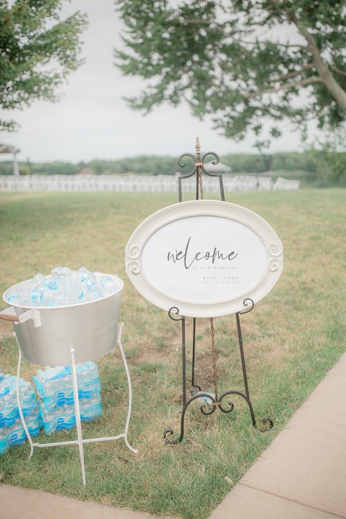 welcome sign by the outdoor ceremony with bottles of water