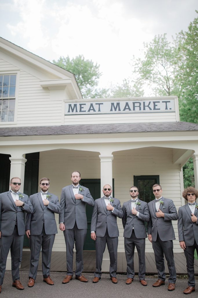 groomsmen in front of Meat Market Sign by Cascade Lofts Trailhead