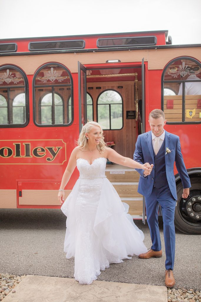 bride and groom walking with the trolley behind them